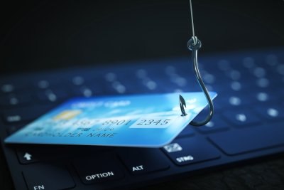 debit card on fishing hook with computer