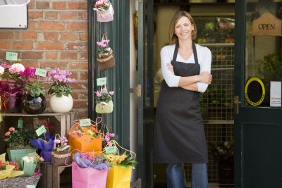 Woman in apron outside flower store