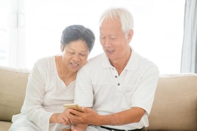 mature couple looking at mobile phone